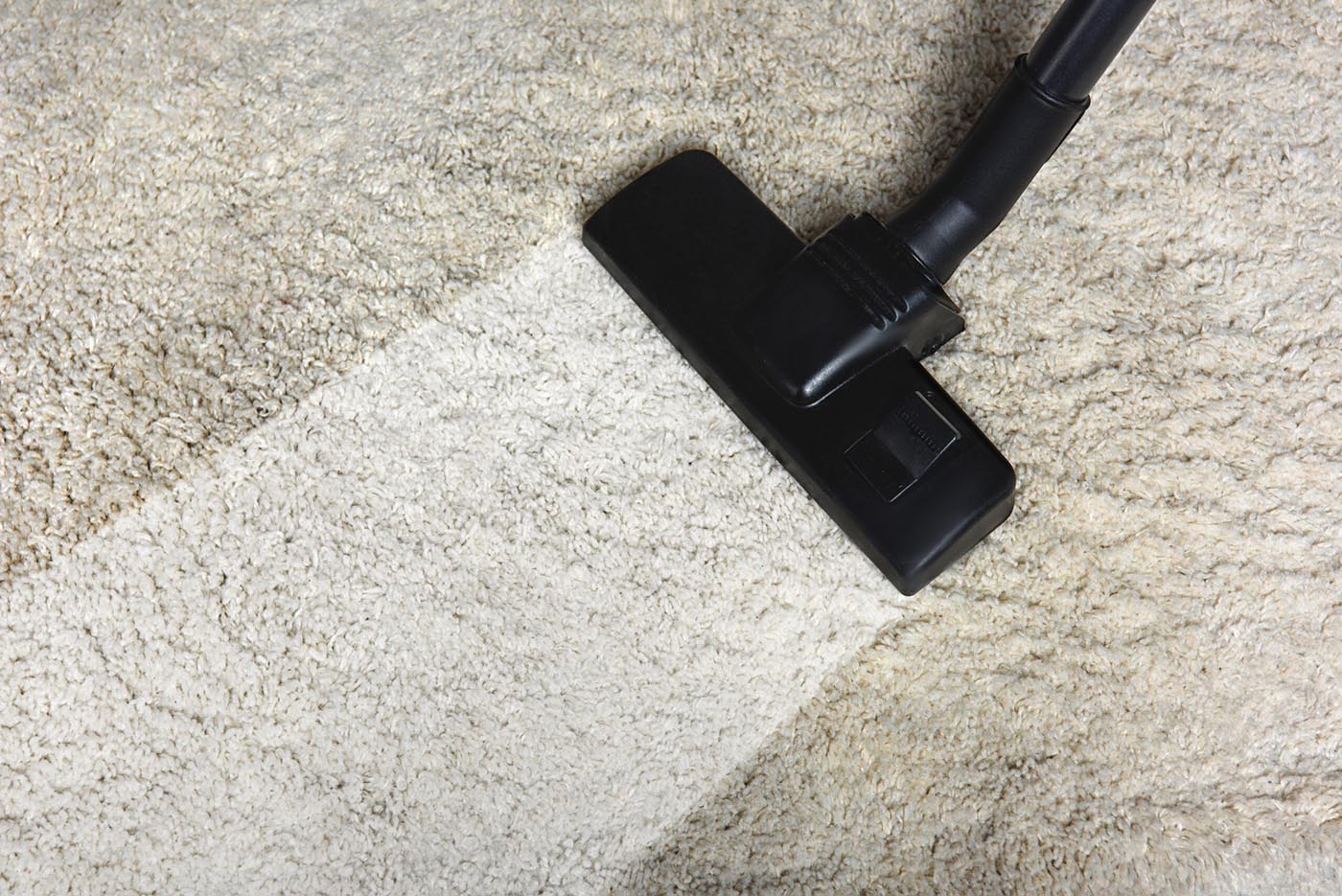 close-up view of cleaning white carpet with professional vacuum